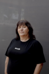 Author photo of Veronica Gorrie, who is wearing a black shirt that reads 'acab'.