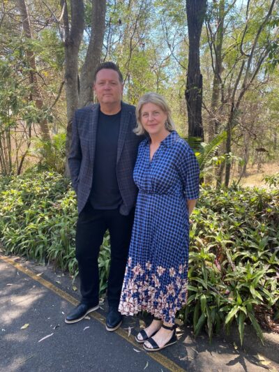 Kári Gíslason with Madonna Duffy, standing in front of some Australian bushland.