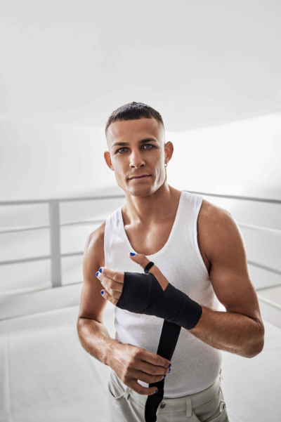 An image of boxer Harry Garside applying a hand wrap