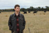 Author Robbie Coburn stands in a paddock.