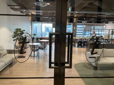 Photograph of Text logo on glass doors to an office space