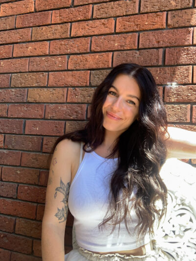 Claire Benson pictured in front of a brick wall