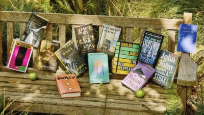 Book Prize longlisted titles displayed on a park bench